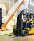 Professional Forklift Jib Boom Crane With 0 To 75 Degree Tilt And 2 Ton 4400 Lb Capacity attached to forklift in warehouse.