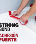 Person applying Underlayment Seam Tape 100 Feet Red For Floating Floors PVC Based Moisture Resistant Easy Tear Seams Bonding.