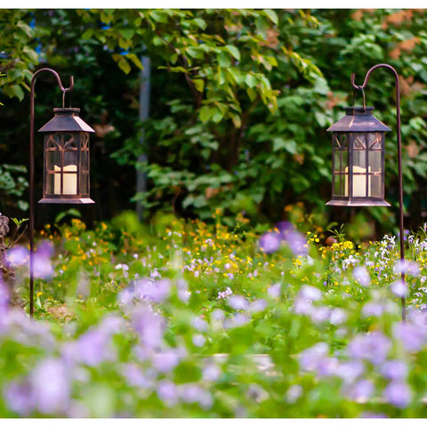 Bronze Hanging Solar Lanterns Two Pack Outdoor Waterproof Decorative Lanterns in garden with LED candles and real glass panels.