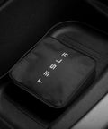 Tesla Mobile Connector Portable EV Charger Level 2 Up To 32 Amps With 20 Ft Cable in black carrying case, placed in vehicle compartment.