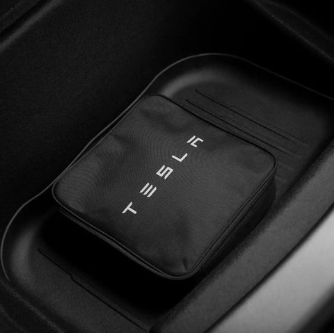 Tesla Mobile Connector Portable EV Charger Level 2 Up To 32 Amps With 20 Ft Cable in black carrying case, placed in vehicle compartment.