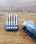 Heavy Duty 5 Pc 1/4 Hex Shank Magnetic Screwdriver Bit Set Featuring U Shape Y Type Inner Cross Three Point Special Heads Built Different With Durable S2 Steel For Power Drills Top Shelf Ace on wooden surface, showcasing five magnetic bits and power drill.