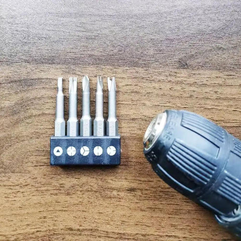 Heavy Duty 5 Pc 1/4 Hex Shank Magnetic Screwdriver Bit Set Featuring U Shape Y Type Inner Cross Three Point Special Heads Built Different With Durable S2 Steel For Power Drills Top Shelf Ace on wooden surface, showcasing five magnetic bits and power drill.