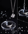 Loose CZ Diamond Stones Kit 2400 Clear Cubic Zirconia Rhinestones In 8 Sizes From 0.8mm To 2.5mm on black surface with necklace and rings