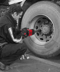 Man using Shop Beast 1 Inch Air Impact Wrench Crunching 1920 Foot Pounds Torque on truck wheel in garage.