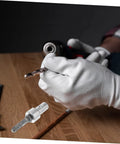 White-gloved hand holding a Garden Auger Drill Chuck Adapter For Hammer Drill And Earth Auger Connector Beast on a wooden table