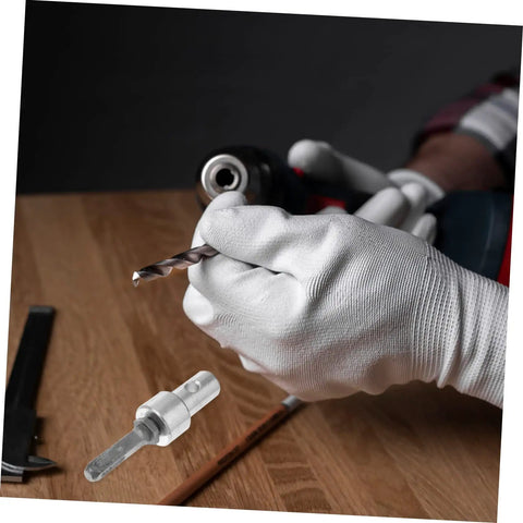 White-gloved hand holding a Garden Auger Drill Chuck Adapter For Hammer Drill And Earth Auger Connector Beast on a wooden table