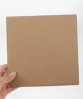 Hand holding a single sheet from 12 Pack Corrugated Paper Filler Sheets For Boxes And Shipping Easy Cut To Size Protective Cardboard Inserts