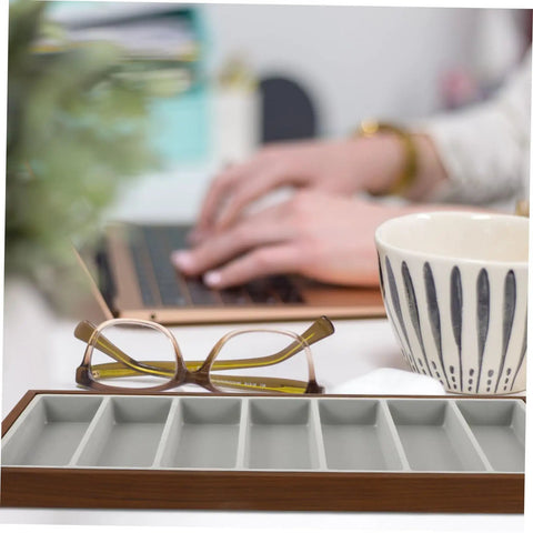 Slick Wooden Sunglasses Display Plate Featuring Seven Grid Slots For Eyeglasses Organization on a desk near glasses and a coffee cup.