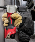 Heavy Duty 10.75 Inch M12 Cordless Rivet Tool Kit Featuring 2000 Pound Pull Force in use with gloved hand on metal.