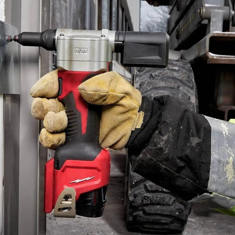 Heavy Duty 10.75 Inch M12 Cordless Rivet Tool Kit Featuring 2000 Pound Pull Force in use with gloved hand on metal.