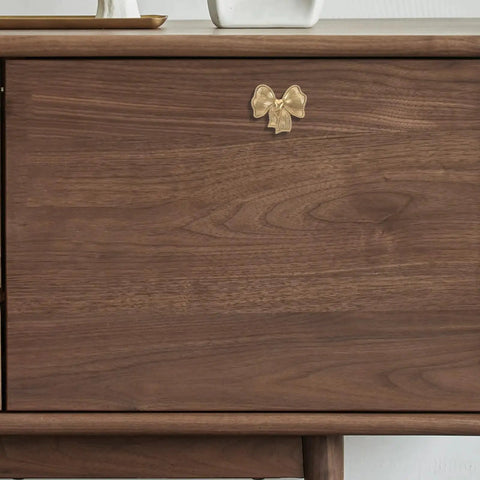 Luxurious Vintage Brass Bow Drawer Handles For Furniture And Boxes. Small gold bow pull on wooden dresser front.