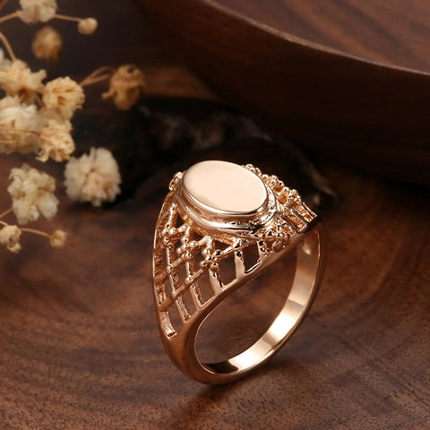 Fresh Rose Gold Oval Mesh Statement Ring For Women Featuring Sleek Polished Surface And Dope Openwork Grid Band seen on wooden surface.