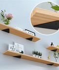 Sick Concealed Floating Shelf Brackets Super Strong Iron Triangle Wall Mounts mounted with wooden shelves displaying decor.