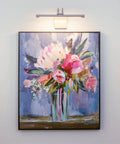 15 Watt Hardwire Adjustable Dimmable LED Picture Light With Antique Brass Finish illuminating artwork of flower bouquet