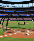 Portable Baseball Batting Cage For Backyard Or Field With Heavy Duty Frame And Net in action on a baseball field