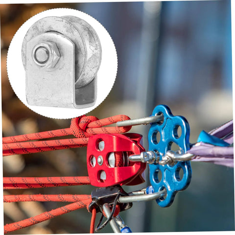 Cast-iron V-type groove wheel on a metal bracket; installed for garage door or gate; inset shows wheel close-up.