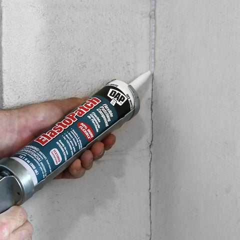 Hand applying ElastoPatch Smooth Flexible Patching Compound White 10.1 Oz Crack Filler For Drywall Plaster Stucco