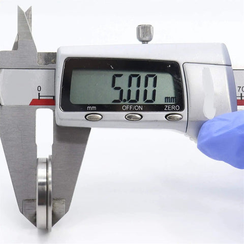 Digital caliper measuring 5.00 mm diameter of a F6802ZZ Flanged Bearing for precision verification.