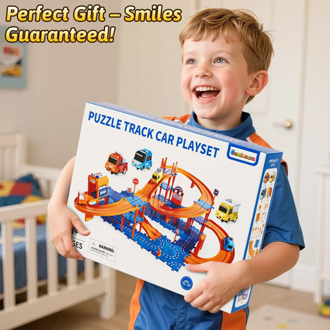 Child smiling holding a box of 4 Tier Race Track Puzzle Set With 3 Cars For Kids Ages 3 To 8 in a playroom setting