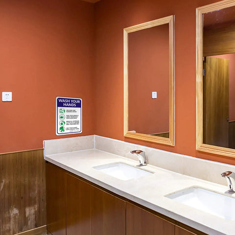 Keep Hands Clean With This Please Wash Your Hands Sign Stickers 4 Pack 10 By 7 Inch 4 Mil Vinyl Self Adhesive Weatherproof UV Protected Indoor Outdoor Employee Hand Washing Sign displayed on wall above sinks in restroom
