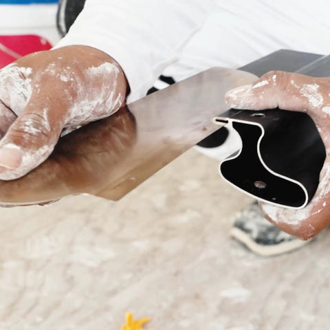 Hands holding Pro Grade 16 Inch Drywall Skimming Blade With Extruded Aluminum Back And European Stainless Steel Blades