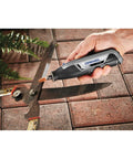 Close-up of Ultra Compact Four Volt Cordless Rotary Tool featuring variable speed in hand, working on garden shears.