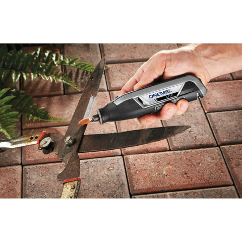 Close-up of Ultra Compact Four Volt Cordless Rotary Tool featuring variable speed in hand, working on garden shears.