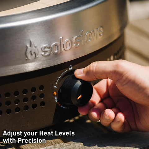Close-up of outdoor pizza oven's stainless steel heat control dial titled 'Adjust your Heat Levels with Precision'