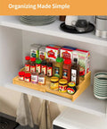 Premium Grade Three Tier Natural Bamboo Spice Rack With Adjustable Cabinet Organizer Shelf For No Sweat Kitchen Countertop Storage displaying spices.