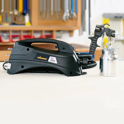 Stationary Hvlp Finishing Sprayer For Woodworkers Wanting Killer Results On Furniture Restoration Projects Using Pro Grade Metal Spray Gun next to a stainless steel container.