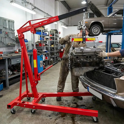 Heavy Duty Folding Hydraulic Engine Hoist With 4400 Lbs Capacity Cherry Picker Crane lifting a car engine in a garage.