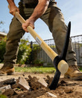 Man using Beefy Heavy Duty Pickaxe With Wood Handle For Digging And Chiseling Forged High Carbon Steel Head 36 Inch Length in yard