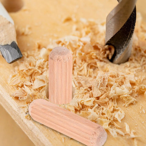Wooden Dowel Pins M8x30mm for Furniture Assembly on wood surface with drill and shavings