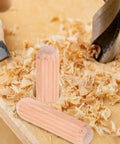 Close-up of 100 Pieces M8x30mm Wooden Dowels for Woodworking Furniture with Stable Grip and No Wobble next to wood shavings.