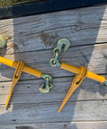 Two yellow powder-coated grab hook binders for 3/8 to 1/2 inch chains, part of 4 Pack Heavy Duty Ratchet Lever Load Binders with 12,000 lb WLL