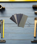 56 Piece Wet And Dry Sanding Sheets Kit With Assorted Grit 400 To 5000 For Wood And Metal on blue wooden table with tools