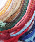 Colorful macrame cords in various shades including beige, showcasing options for macrame projects, not specific to Natural Macrame Cord 3mm 109 Yards Beige Cotton Rope For Wall Hangings Plant Hangers Christmas Crafts Knitting And DIY Projects Soft Durable Cotton Fiber Perfect For Macrame Wall Art Boho Planters Jewelry And Gift Wrap.