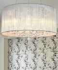 Raindrop Crystal Drum Chandelier With Fabric Shade hanging with sparkling K9 crystal glass in modern living room decor.