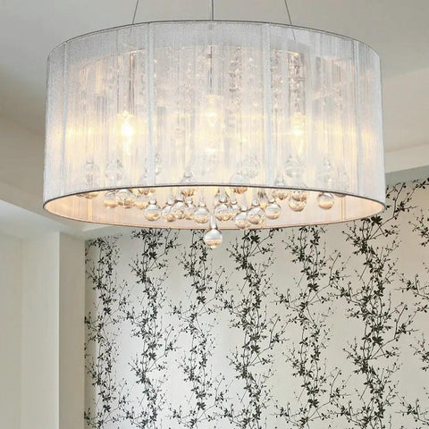 Raindrop Crystal Drum Chandelier With Fabric Shade hanging with sparkling K9 crystal glass in modern living room decor.