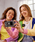 Two women using Plug-And-Play Ultra Compact Wireless Microphone System with Built-In Mics indoors for content creation.