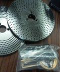 Two 12 Inch Precision Rotary Table index plates with holes and a bagged accessory for 10 Inch 3 Jaw Chuck Reversible Jaws.
