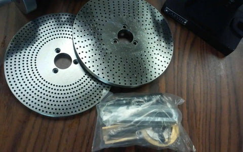 Two 12 Inch Precision Rotary Table index plates with holes and a bagged accessory for 10 Inch 3 Jaw Chuck Reversible Jaws.