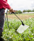 Person using Pro Grade Windproof Sprayer Nozzle With Shield For High Pressure Misting Garden And Farm Crop Spray Coverage Efficient Replacement Part For Agricultural Sprayers in field