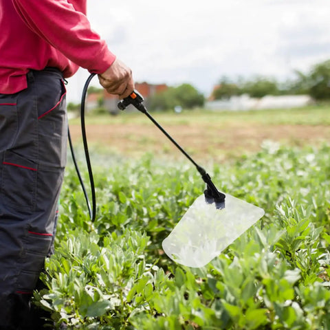 Person using Pro Grade Windproof Sprayer Nozzle With Shield For High Pressure Misting Garden And Farm Crop Spray Coverage Efficient Replacement Part For Agricultural Sprayers in field