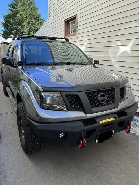 Premium Steel Ditch Light Brackets For 2005-2017 Nissan Xterra And Frontier mounted on a gray Nissan with LED lights.