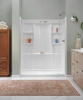 Modern bathroom with brushed nickel faucet on white sink, featuring a spacious shower, wooden cabinet, and elegant decor.