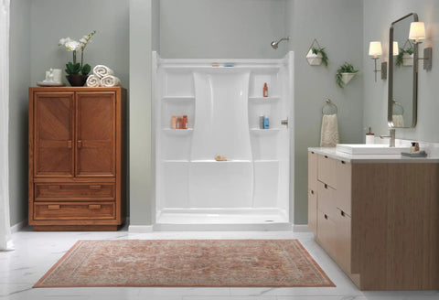 Modern bathroom with brushed nickel faucet on white sink, featuring a spacious shower, wooden cabinet, and elegant decor.