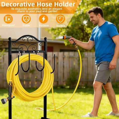 Black heavy duty garden hose holder stand with 100-foot hose and quad-anchor base in yard, man using hose