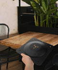Premium Heavy Cast Iron Table Leg Connector Brackets With Grip Tight Screws for furniture repair shown in hand near wooden table.